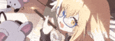 a girl with glasses is holding a pencil in her mouth while sitting at a desk .