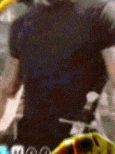 a blurred image of a person wearing a black shirt with the word adidas on it