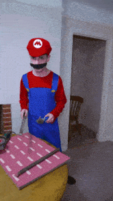 a man in a mario costume holds a hammer