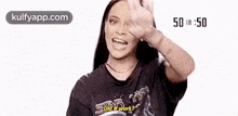 a woman wearing a black t-shirt is making a funny face and asking , did it work ?