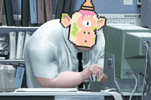 a man with a pixelated monkey on his head sits in front of a computer monitor