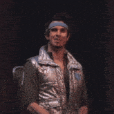 a man in a futuristic outfit sits in a chair
