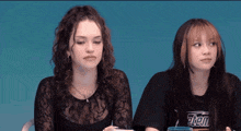 two girls are sitting next to each other with one wearing a shirt that says " stem "