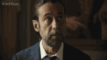 a man with a beard in a suit and tie with the hashtag jackryan