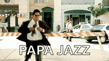 a man in a suit and tie is running down a street with the words papa jazz written on the bottom