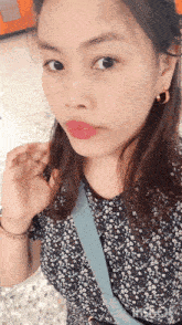 a close up of a woman 's face with a floral top