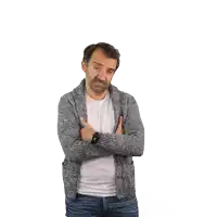 a man with his arms crossed wears a watch