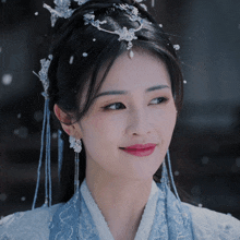 a close up of a woman wearing a blue dress