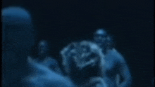 a blurry picture of a man and a woman in a dark room