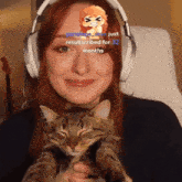 a woman wearing headphones is holding a cat with the words resubscribed for 32 months visible on her face