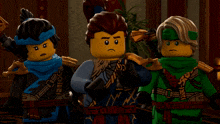 three lego figures are standing next to each other with one wearing a blue scarf that says ninja