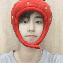 a person wearing a strawberry hat with yellow spots