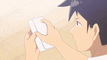 a cartoon of a man holding a piece of paper with chinese writing on the bottom