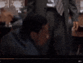 a man in a suit and tie is talking to another man in a suit and tie