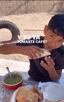 a young boy sitting at a table eating food with the words " y tu ya tomaste cafe " written above him