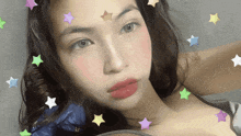 a close up of a woman 's face with stars on her face