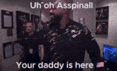 a man in a ufc shirt is standing in a room with a sign that says `` your daddy is here '' .