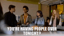 a group of people are standing in a room with the words you 're having people over tonight