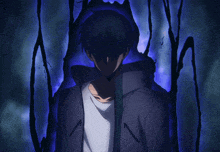 a man in a hoodie is standing in the dark