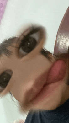a close up of a person 's face with their tongue hanging out