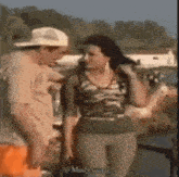 a man and a woman are standing next to each other on a beach .