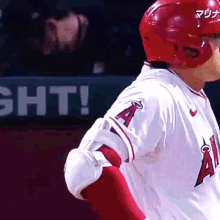 a baseball player wearing a red helmet and a white jersey with the letter a on the sleeve