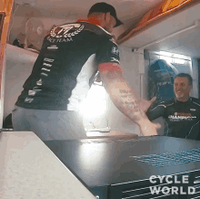 a man wearing a black shirt that says race team
