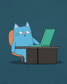 a blue cat is sitting at a desk with a laptop on it