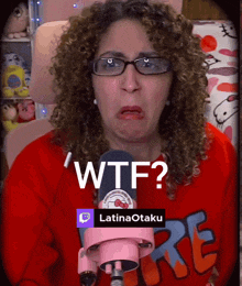a woman with curly hair is wearing glasses and a red shirt that says ' wtf ' on it