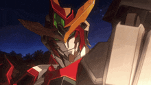 a close up of a robot with green eyes and a red and yellow helmet