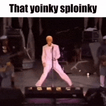 a man in a white suit is dancing on a stage in front of a microphone with the caption that yoinky sploinky .