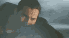 a man with a beard is flying through the air while holding a gun .
