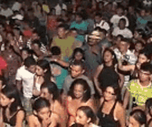a large crowd of people are gathered in a room at a party .