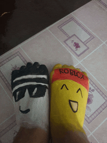 a person 's feet painted to look like a roblox character