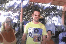 a man wearing a yellow t-shirt with a picture of a man on it