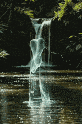 a waterfall with a heart shaped object in the middle