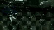 a person is standing in front of a checkered wall with a broken glass .