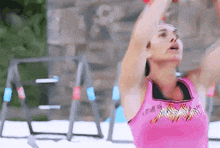 a woman in a pink tank top with a tiger print