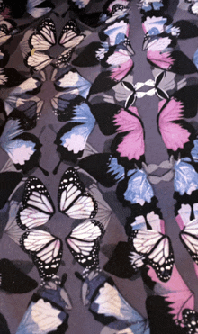 a pattern of butterflies on a grey background