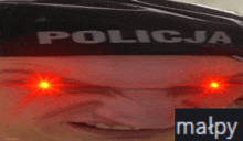 a close up of a person 's face with the word policja on it