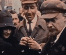 a group of men are standing in a crowd with a sign that says 24 ack