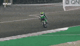 a man riding a motorcycle on a track with the number 87 on it