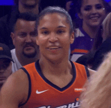 a female basketball player wearing a jersey that says ' phoenix ' on it