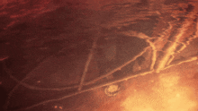 a blurred image of a fire with a reflection of a person in the water