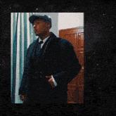 a man in a suit and hat is standing in front of a door with the words clmr-shelby written above him