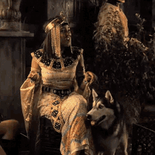 a woman in a costume is sitting next to a dog