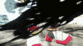a blurred image of a person 's legs with a red and white stripe on them .