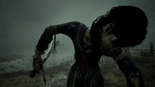 a person holding a large sword in a foggy area