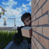 a man is peeking out from behind a brick wall with a box in his hand