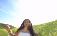 a woman in a white dress is standing in a field of tall grass